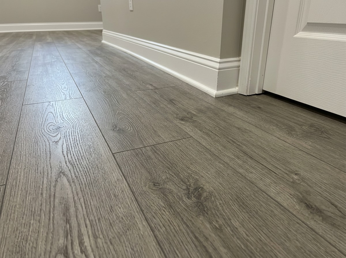 Close-up of waterproof luxury vinyl plank flooring installed in a finished Hanover Park basement
