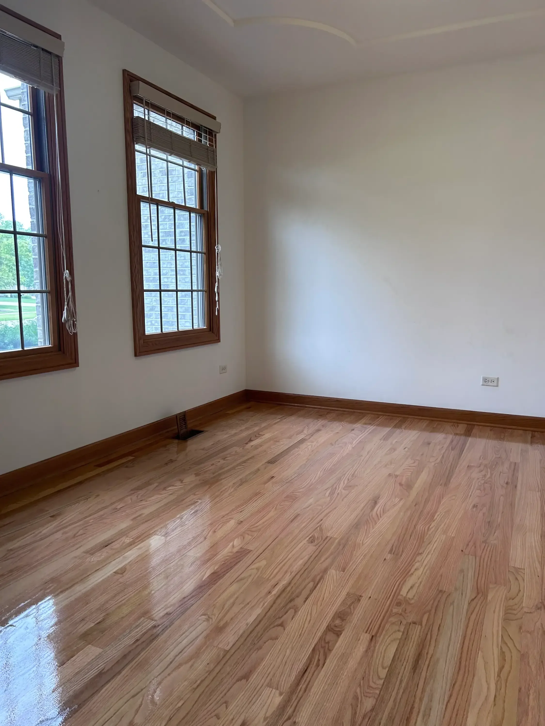 Newly installed hardwood flooring with warm wood tones and satin finish in residential room
