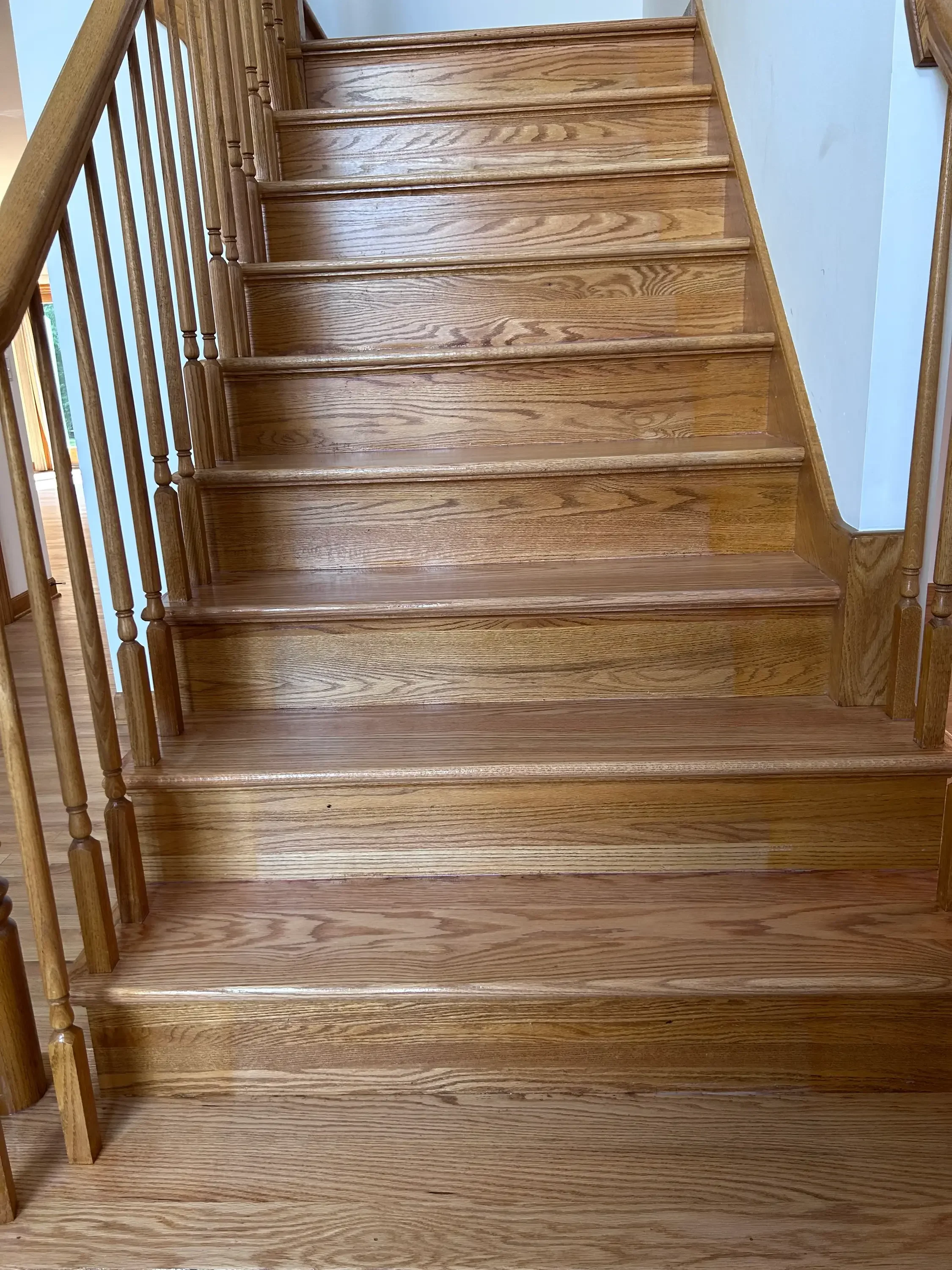 Solid oak staircase with finished treads, risers, and turned balusters